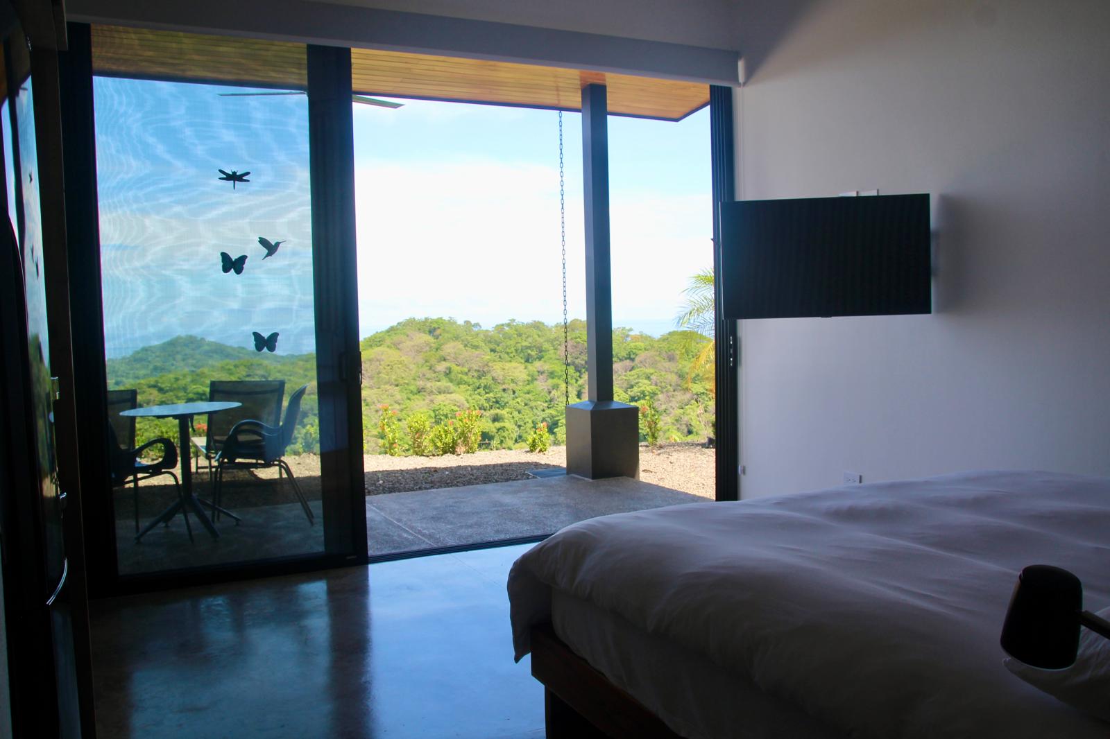 Casa Playa Carrillo — bedroom opening through sliding glass doors to a private terrace