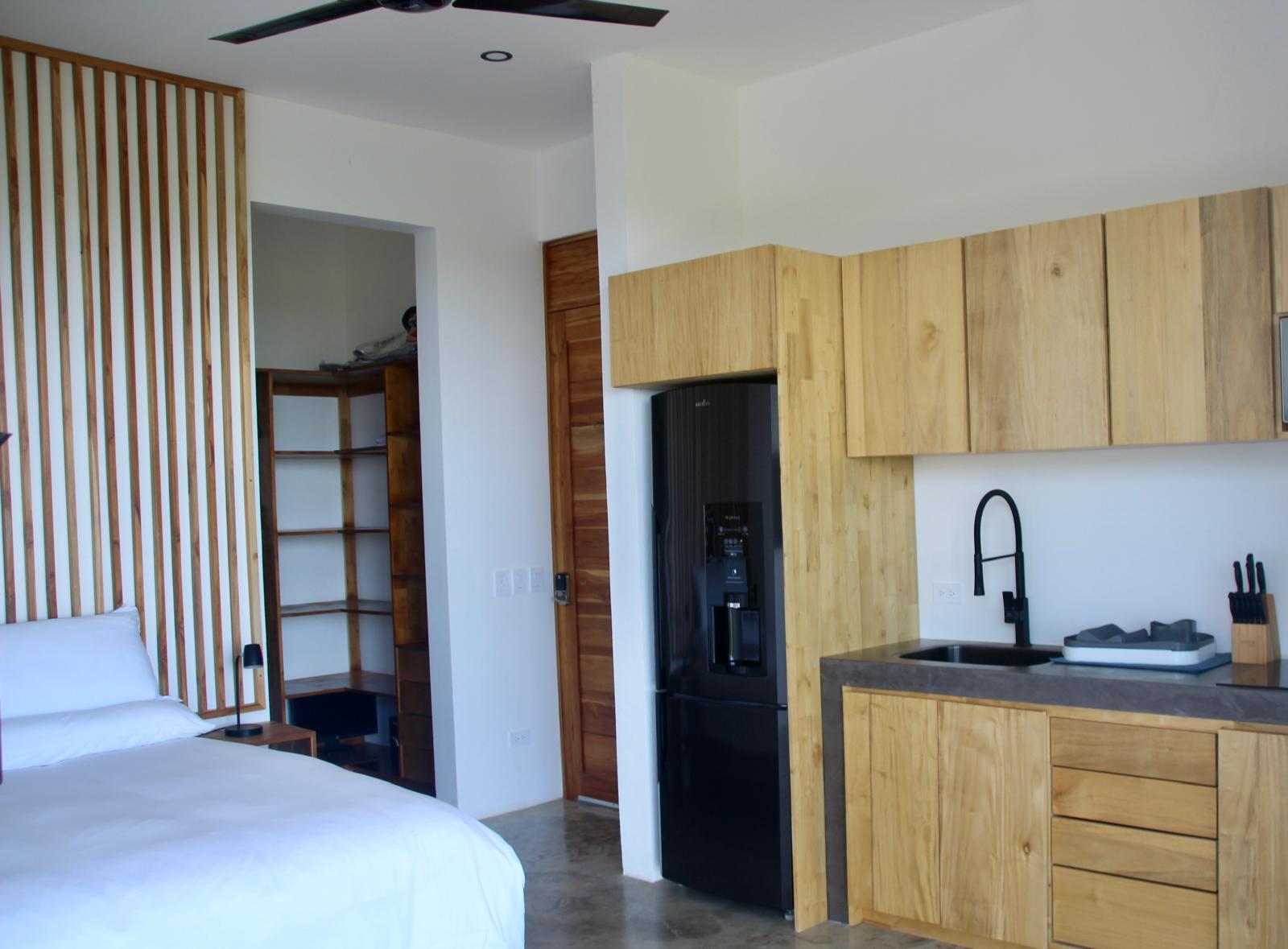 Casa Playa Carrillo — guest suite with teak kitchenette and slatted wood screen