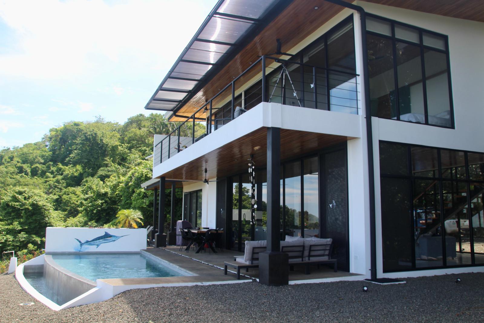 Casa Playa Carrillo — the two-level house and infinity pool seen from the garden
