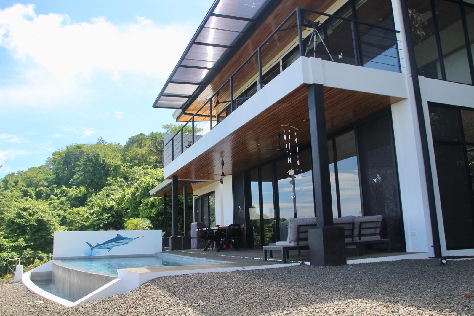 Casa Playa Carrillo — corner view of the pool terrace and cantilevered upper balcony