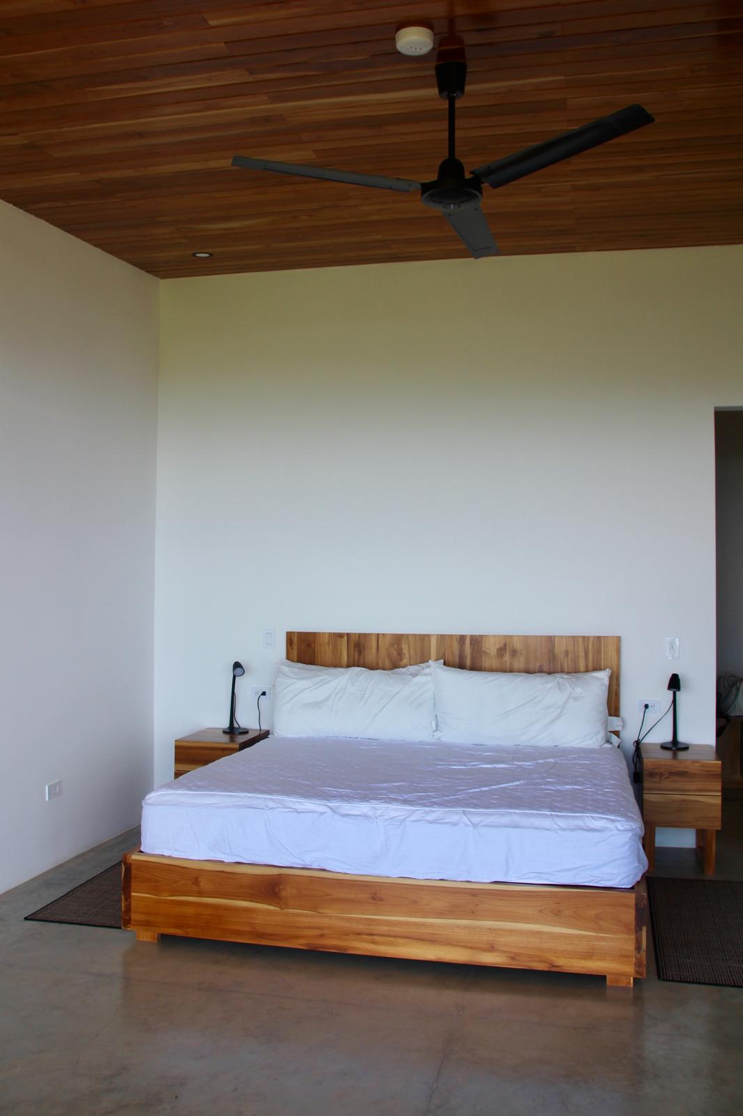 Casa Playa Carrillo — bedroom with teak platform bed and timber ceiling